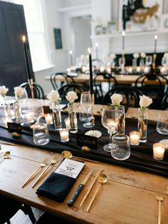 a long table with candles and place settings