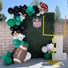 balloon arch with footballs and balloons on it