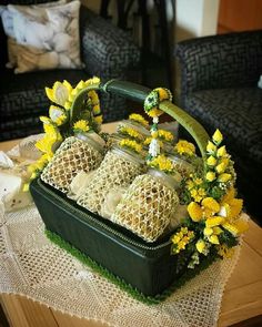 a basket filled with yellow flowers sitting on top of a table