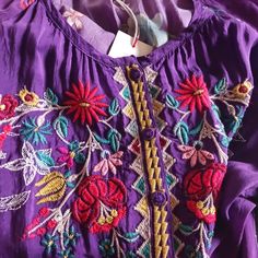 It Is Purple With Multiple Colors Of Embroidery. It Is So Striking. 100% Rayon. 3/4 Sleeves With Elastic At Sleeve Opening (Loose Fit). Buttons On Bodice Only. Pullover Style. Loose And Flowy. Pair With White Linen Pants At The Resort, And You Will Stop Everything And Everyone! It Says It Is A Medium, But This One Runs Large. It Would Fit An Xl Comfortably! Embroidered Bohemian Purple Blouse, Purple Embroidered Top With Floral Embroidery For Summer, Bohemian Embroidered Purple Blouse, Bohemian Purple Blouse With Floral Embroidery, Purple Embroidered Bohemian Blouse, Purple Floral Embroidered Top For Summer, Bohemian Purple Embroidered Blouse, Bohemian Purple Top With Floral Embroidery, Purple Bohemian Top With Floral Embroidery