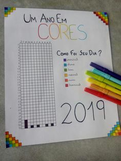 a sheet of paper with colored crayons on it next to markers and pencils