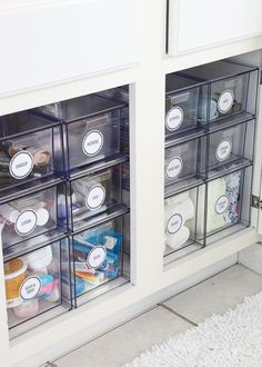 an organized pantry with clear bins and labels on the doors to keep things fresh