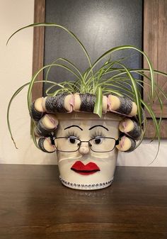 a planter with an image of a woman's head on top of it