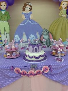 a table topped with cake and cupcakes covered in frosting