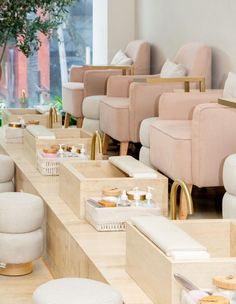 the interior of a nail salon with manicure tables and stools