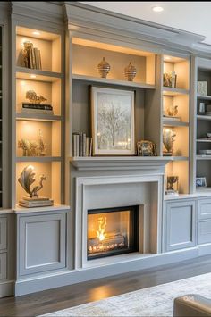 a living room filled with furniture and a fire place in the middle of it's built - in bookcases