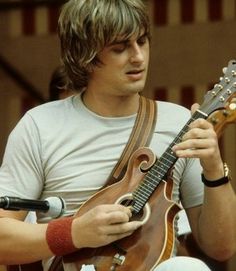 a man playing an electric guitar on stage