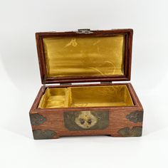 an open wooden box with gold in it