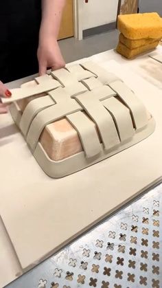 a person is making a cake on a table