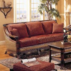 a living room filled with furniture and a fire place next to a couch, coffee table and chair