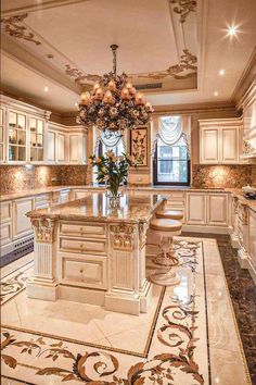 a fancy kitchen with an island and chandelier in the center, surrounded by marble flooring