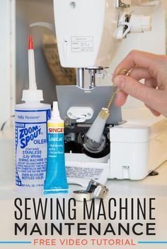 a person is using a sewing machine to sew something on the counter with other items nearby