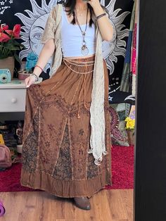 Introducing our Pari Vintage Vibe Brown Embroidery Maxi Skirt, perfect for embracing those boho and hippie vibes! This stunning skirt features pleated borders that add a touch of elegance, while the maxi length offers a chic and comfortable fit.Crafted with fairly-core fashion inspiration, this skirt is ideal for creating enchanting cottage-core looks. Whether you're strolling along sandy shores or exploring hidden getaways, this skirt will ensure you're dressed to impress. Its flowing silhouette captures the essence of fairy-core aesthetics, evoking a sense of whimsy and magic.Designed for the boho fashionista in you, it is versatile and easy to style. Pair it with a cropped top and woven sandals for a carefree bohemian look, or opt for a lace blouse and floppy hat for a more sophisticate Bohemian Maxi Skirt With Boho Print For Beach, Boho Print Bohemian Maxi Skirt For Beach, Bohemian Beach Maxi Skirt With Boho Print, Beach Bohemian Maxi Skirt With Boho Print, Bohemian Boho Print Maxi Skirt For Beach, Hippie Festival Skirt Bottoms, Spring Bohemian Flowy Maxi Skirt, Flowy Bohemian Maxi Skirt For Spring, Bohemian Maxi Skirt For Spring