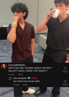 two men standing next to each other drinking coffee