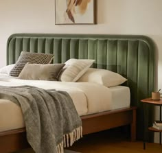 a green headboard on a bed in a bedroom