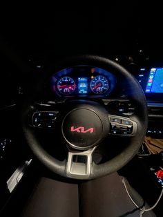 the interior of a car with dashboard lights and gauges on display at night time