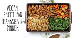 a wooden tray filled with veggies, meats and thanksgiving dinner dressing next to a spoon