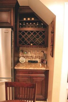 a kitchen with wooden cabinets and stainless steel refrigerator