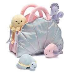 two stuffed animals and a purse on a white background