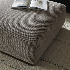 an open book sitting on top of a footstool