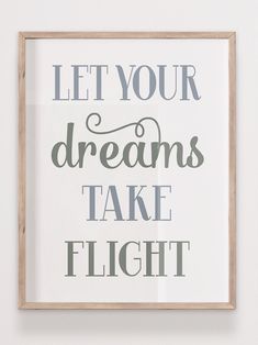 a framed poster with the words let your dreams take flight in grey and white on it