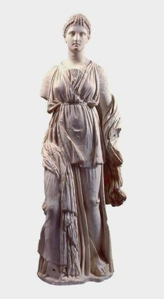 a statue of a woman holding a purse and wearing a dress with her hands in her pockets