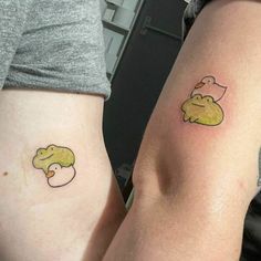 two people with matching tattoos on their legs, one has an elephant and the other has a duck