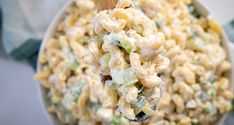 a wooden spoon full of macaroni salad