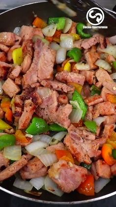 meat and vegetables being cooked in a skillet