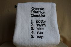 there is a towel with the words over 40 triathlon checklist written on it