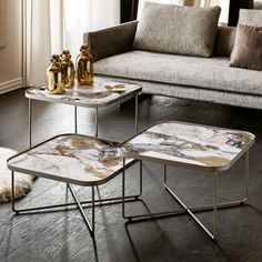 three tables sitting on top of a hard wood floor next to a couch and window