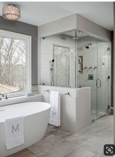 a bathroom with a large tub and walk in shower