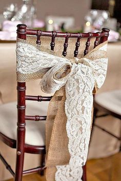 a chair decorated with burlock and lace for a special occasion at the table