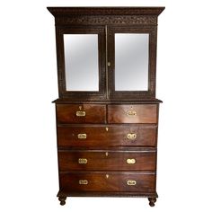 an antique wooden dresser with mirror doors and drawers