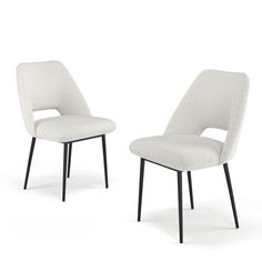 two white chairs sitting next to each other