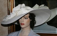 "Are you looking for a Kentucky Derby hat that will wow everyone at your next event? Look no further than East Angel Harbor's Kentucky Derby Hat inspired by the famous Titanic. This beautiful 22 inch wide brim designer faux straw hat in white is guaranteed to get everyone talking! The adornment is a huge silk bow and silk hat band that will add a touch of grace and elegance to your look. Whether its attending the Kentucky Derby, a Titanic movie event or a tea party, this stunning piece is perfec Elegant Curved Brim Top Hat For Formal Occasions, Elegant Wide Brim Top Hat For Formal Occasions, Elegant White High Crown Mini Hat, Elegant Cloche Top Hat For Church, Elegant White Brimmed Costume Hats And Headpieces, Elegant White Brimmed Costume Hat, Elegant Wide Brim Top Hat, Elegant Short Brim Hat, Elegant Fitted Cream Top Hat