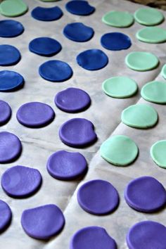 purple, green and blue polka dot cookies are on the baking sheet ready to be baked