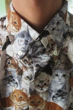 a person wearing a shirt with cats on it