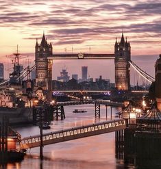 the tower bridge is lit up at night