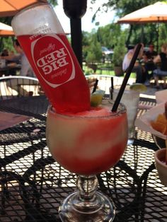 a drink sitting on top of a glass filled with liquid