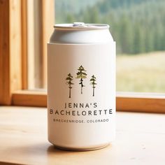 a can of beer sitting on top of a wooden window sill next to a window