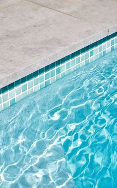 an empty swimming pool with clear blue water