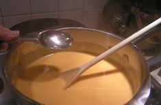 a ladle is being used to stir food in a pot