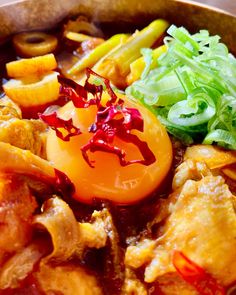 a wooden bowl filled with meat and veggies