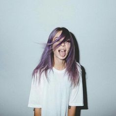 a girl with purple hair is making a funny face