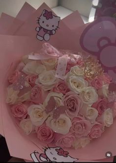 a hello kitty box filled with pink and white roses