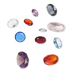 several different colored stones on a white background