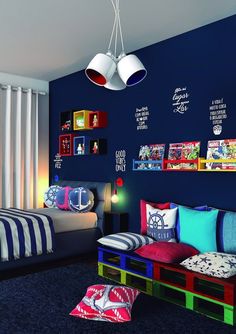 a bedroom with blue walls and pictures on the wall above the bed is decorated in bright colors