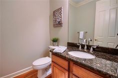 a white toilet sitting next to a bathroom sink