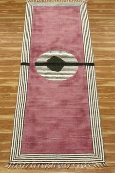 a pink rug with black and white stripes on it